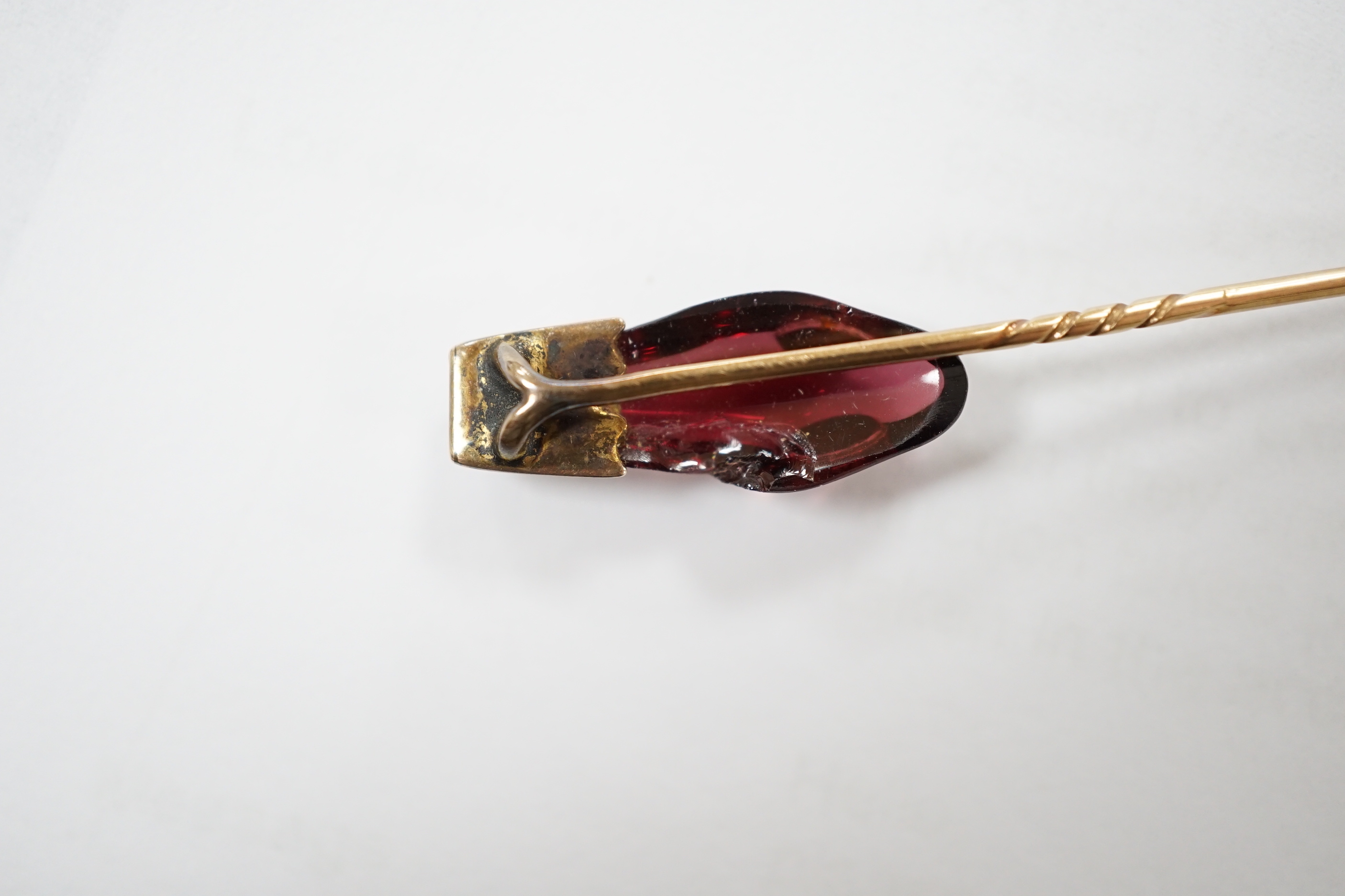 A late Victorian yellow metal, garnet and diamond set serpent head stick pin, 65mm, gross weight 2.9 grams (chip).